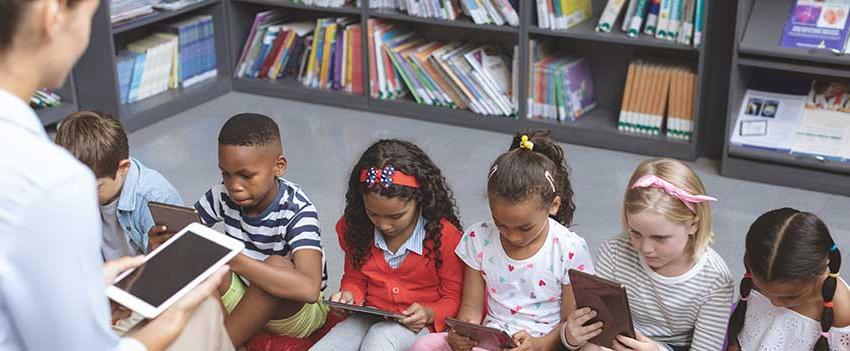 Children reading books in class.