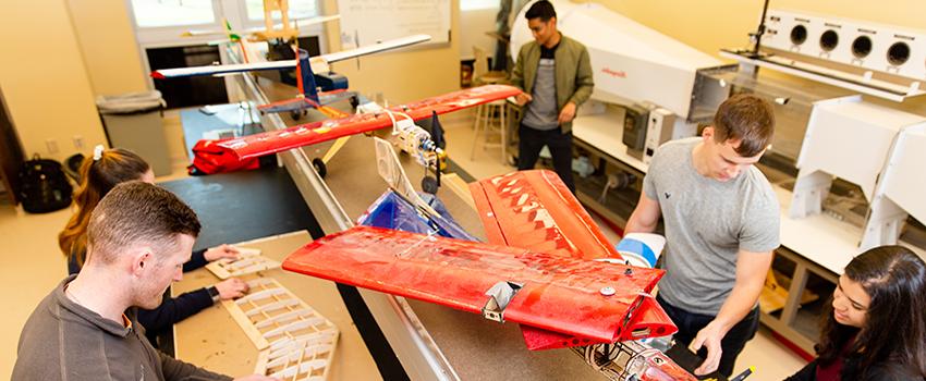 Mechanical Engineering students working on planes