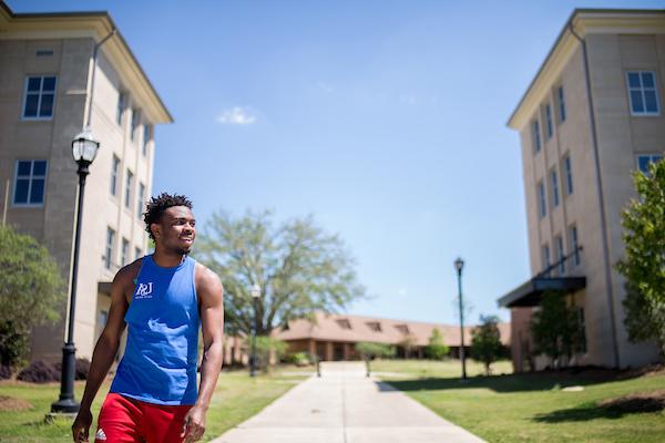 Student walking between dorms on campus.